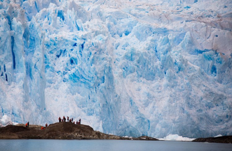 Trekkers hiking near a glacier in Patagonia